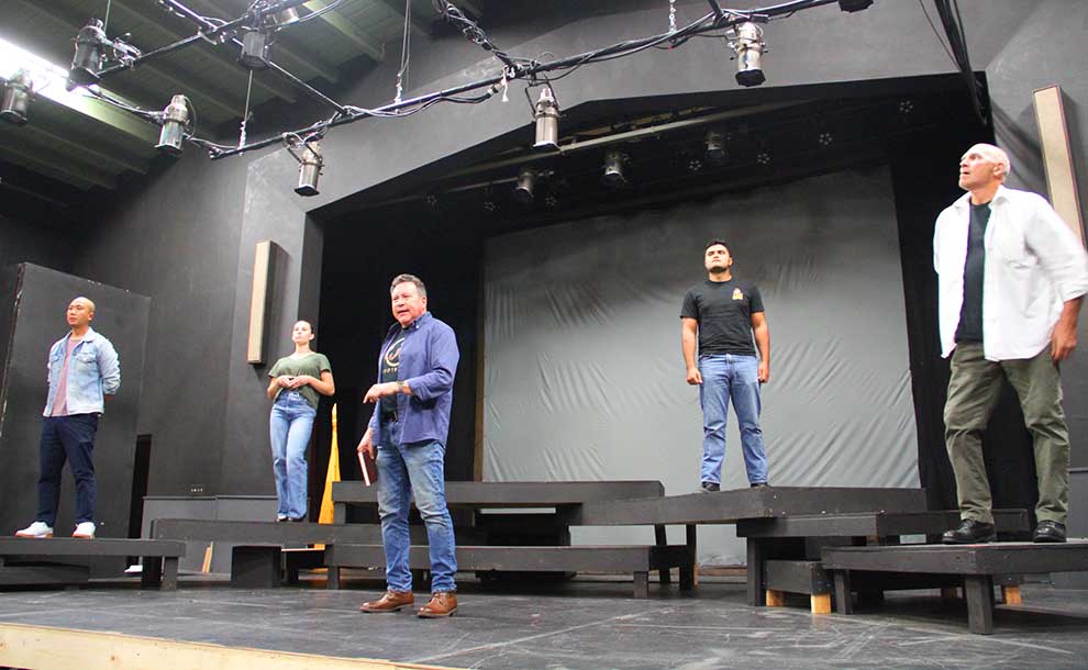 men on stage looking forward