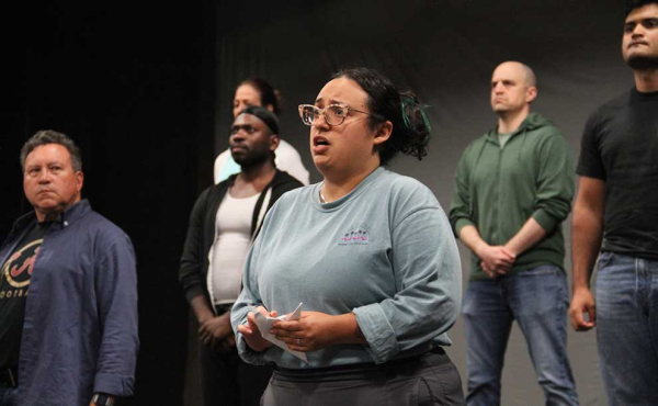 One woman and men looking ahead