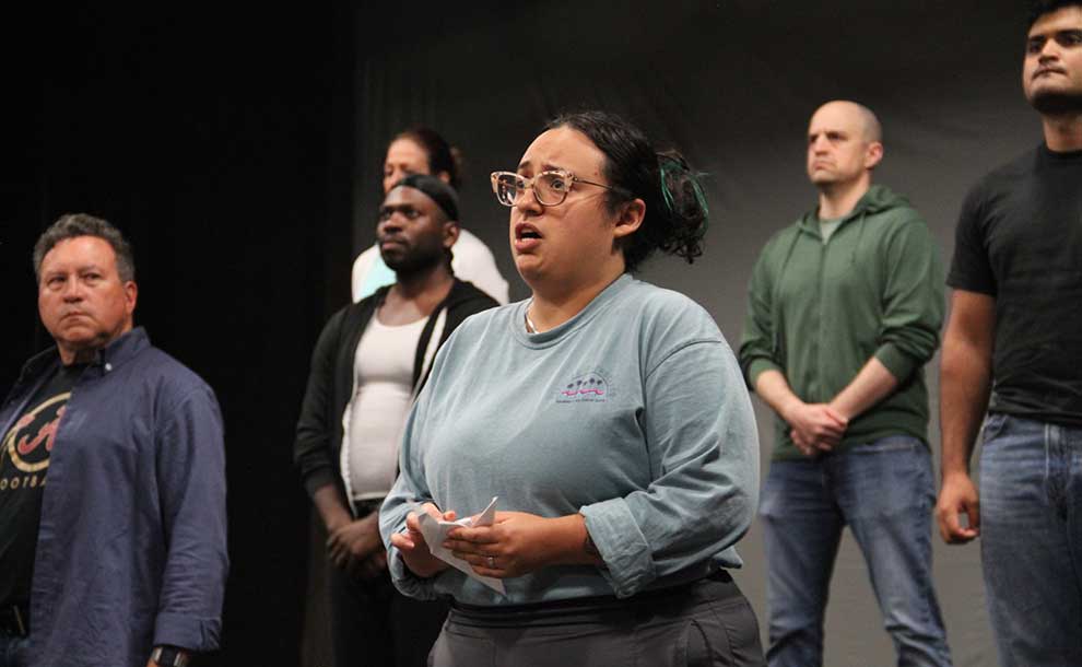 One woman and men looking ahead