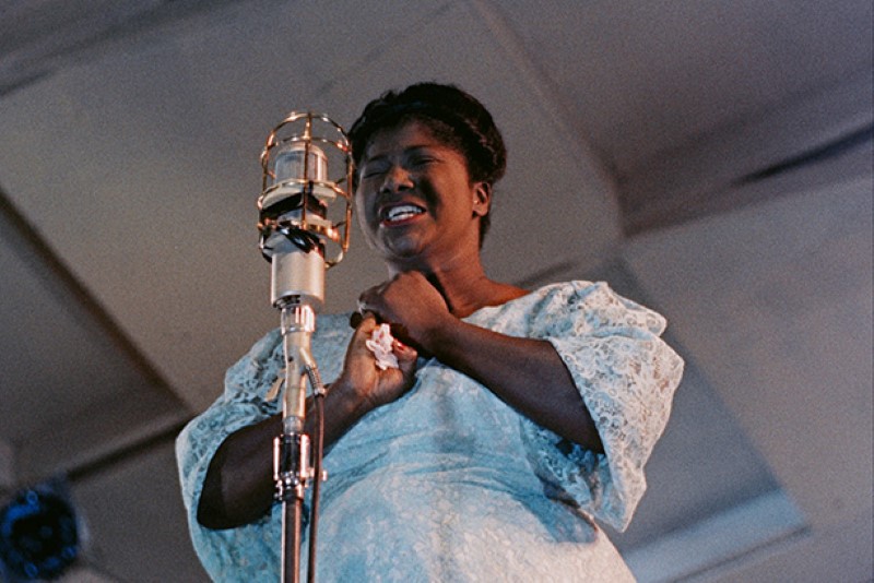 A woman singing into a microphone