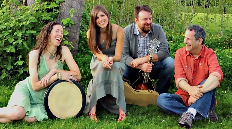 4 musicians sitting with instruments