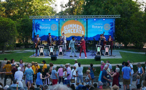 singers on stage and people dancing on the floor