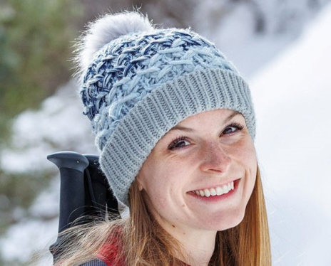 A woman in a beanie smiling
