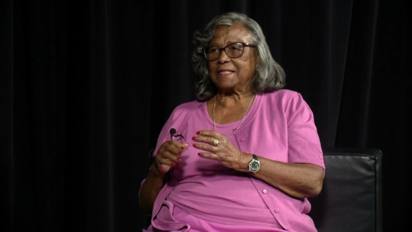 A women gesturing with her hands mid-conversation