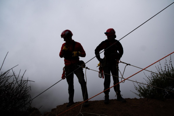 Two mountain rescue people on ropes