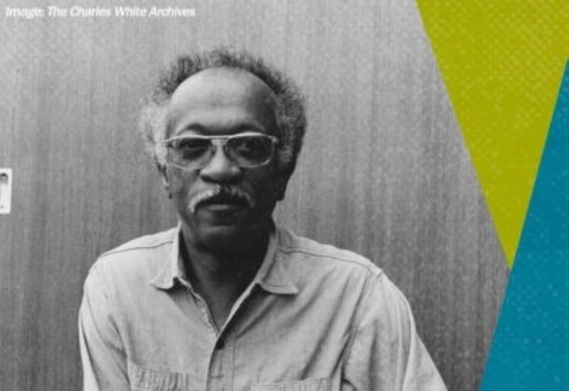 A black and white photo of a man in glasses