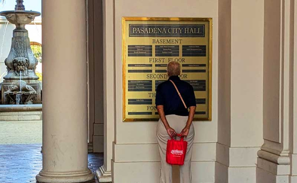 A woman checking the directory at a building