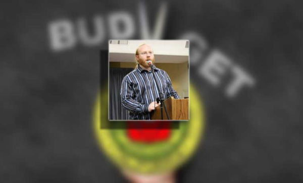 A man speaking over a podium