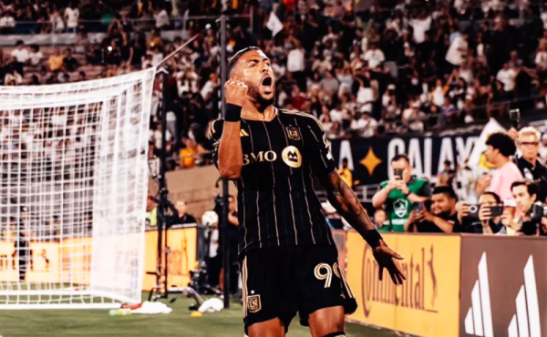 a player on the field celebrating with his fist in the air