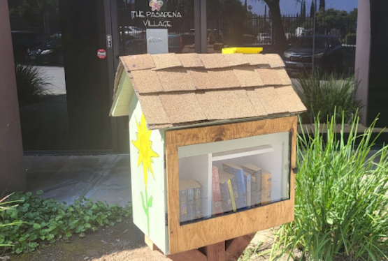 A small wooden library filled with books