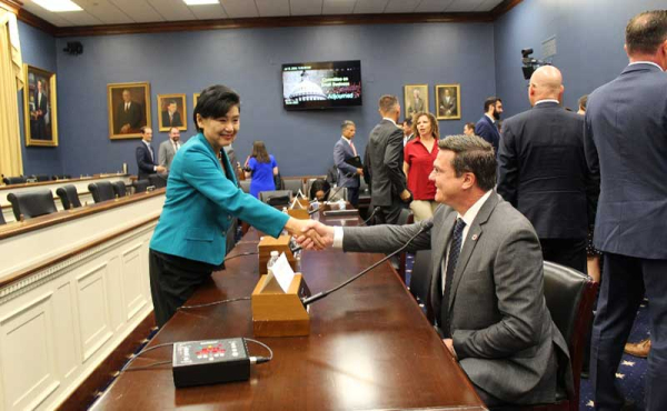 A woman and a man shaking hands man