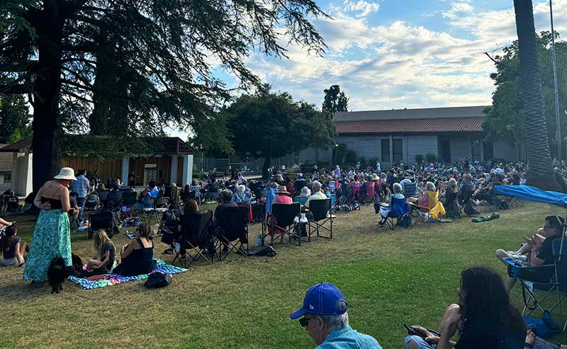 people sitting on beach chairs listening to music