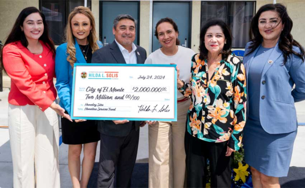 A group of people with an oversized check