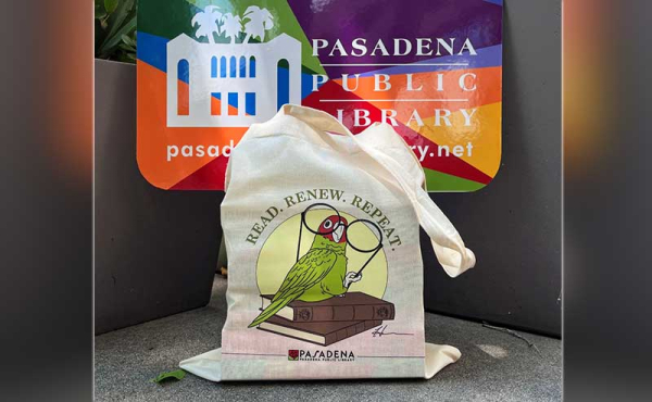 A tote bag next to a logo of the library