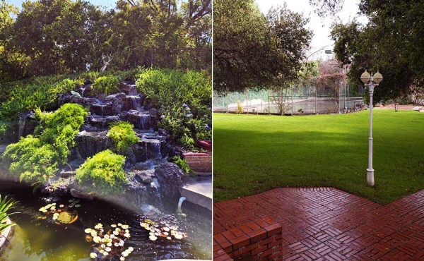 a cascading waterfall and a green lawn