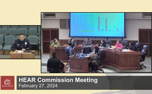 a person sitting while a group of people are on a dais