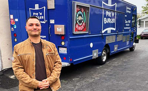 A man standing by a food truck