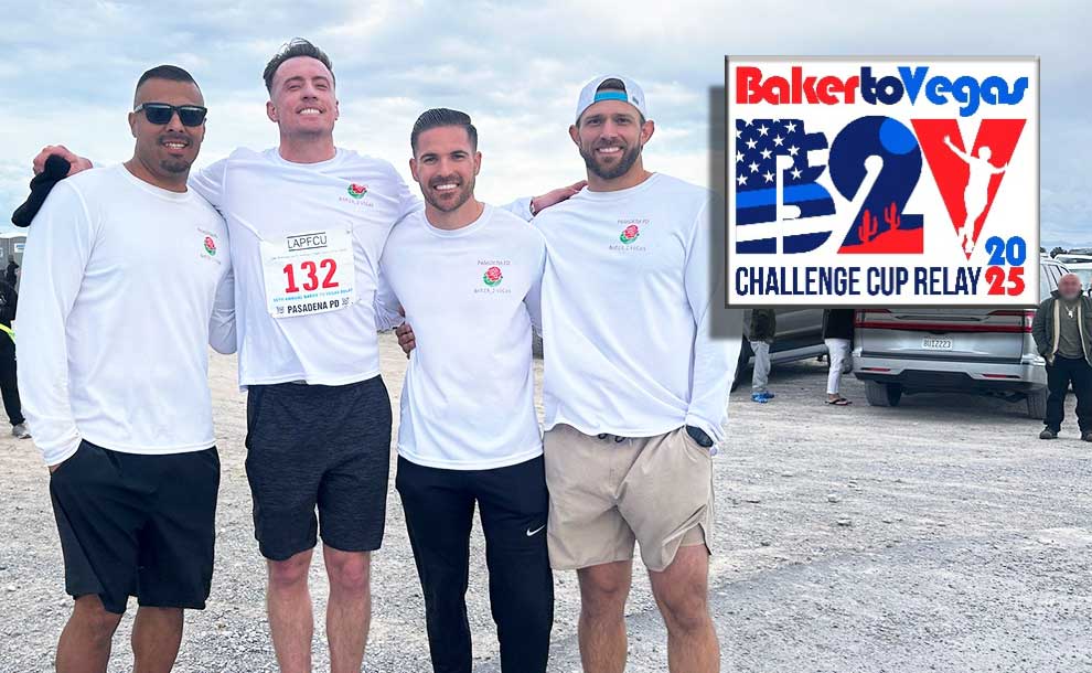 4 guys posing for a photo next to a design