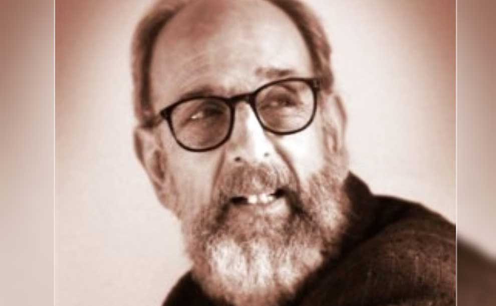 A man with glasses smiling