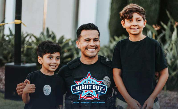 a police officer taking a photo with two kids