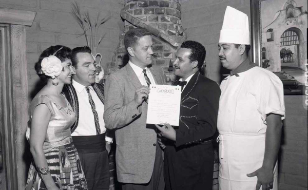 A vintage photo of a chef and people getting an award