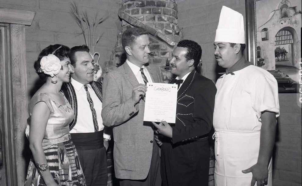 A vintage photo of a chef and people getting an award