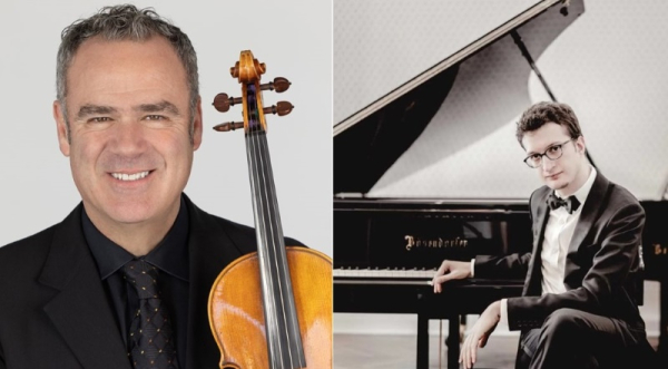 A man holding a violin and another man sitting next to a piano