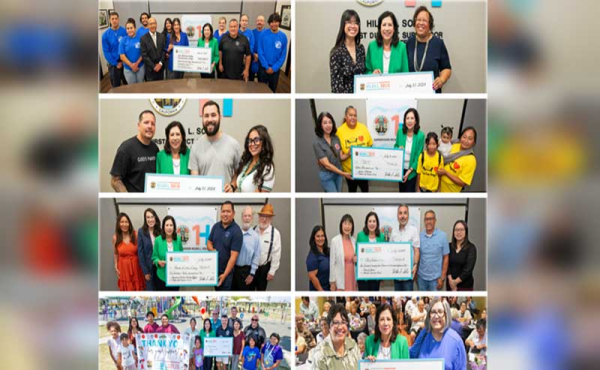 people holding oversized checks