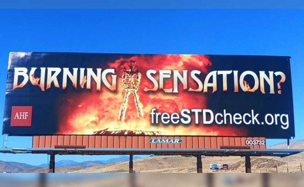 A billboard on the side of a road
