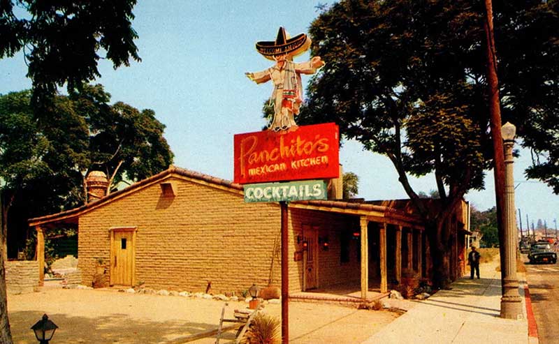 a building with a Mexican character wearing a sombrero