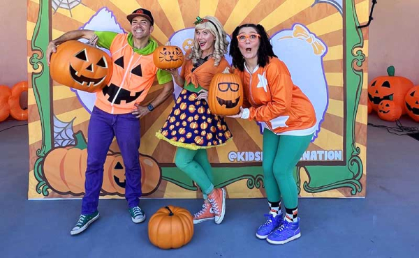 three adults dressed in festive fall outfits