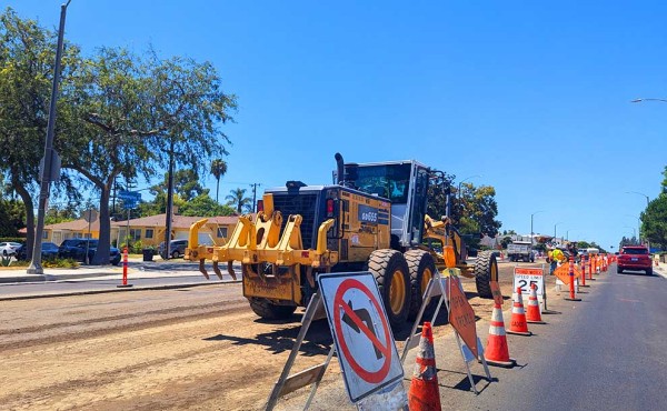 a machine removing cement from a street