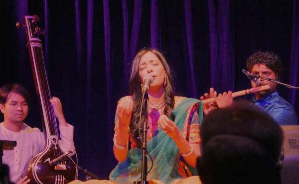 a woman singing on stage