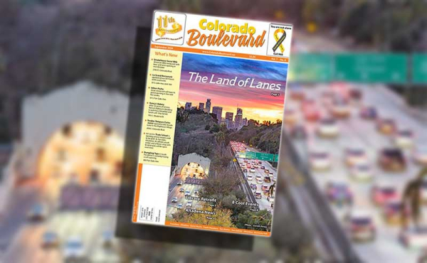 a cover of a newspaper with freeway, cars and a tunnel