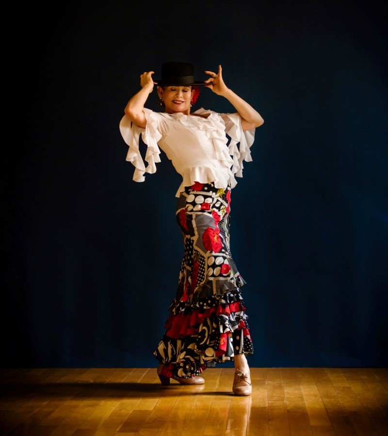 A dancer posing with a hat