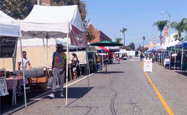 shoppers at a market with tent