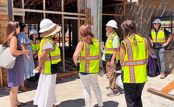 group of people checking out a construction site