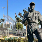 a statue of a Baseball player in a park