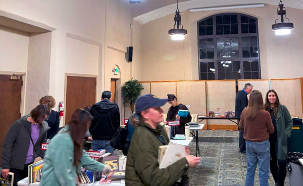A woman holding a bunch of books