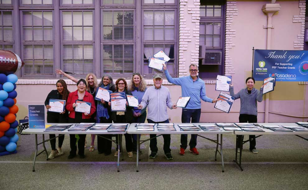 group of people holding awards