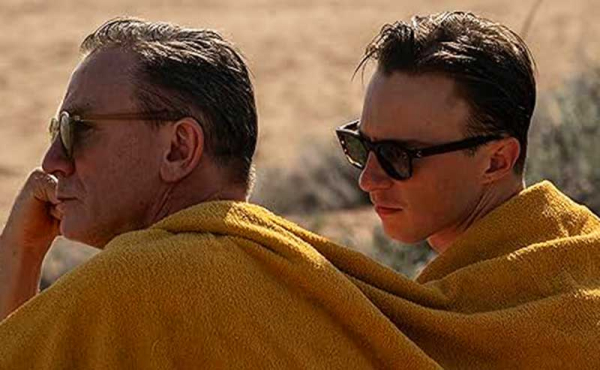 two men sitting on the beach