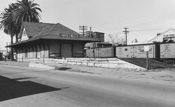 a black and white photo of a train depot