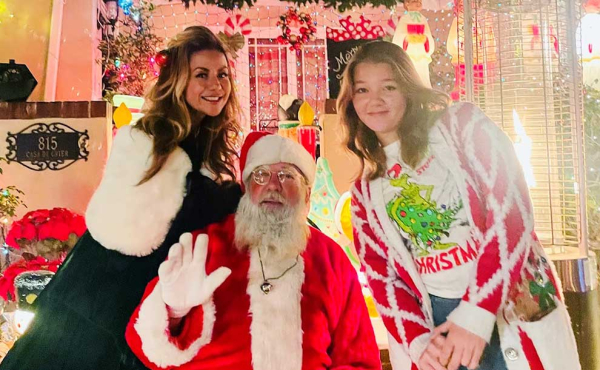 two people taking a photo with Santa