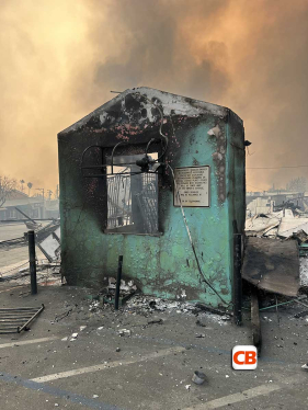 A burned down building surrounded by smoke
