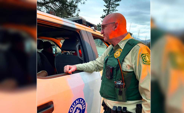 an officer talking to a person in a car