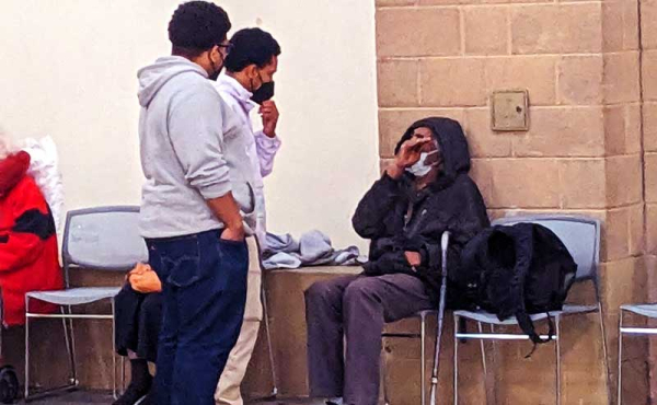 two guys checking on an evacuee