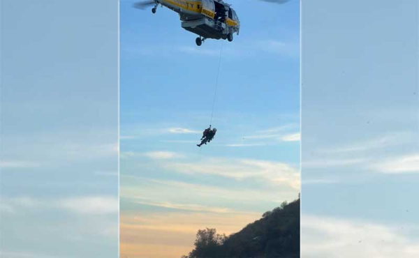 a helicopter lifting a teenager