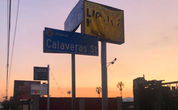 a burnt sign and a street sign