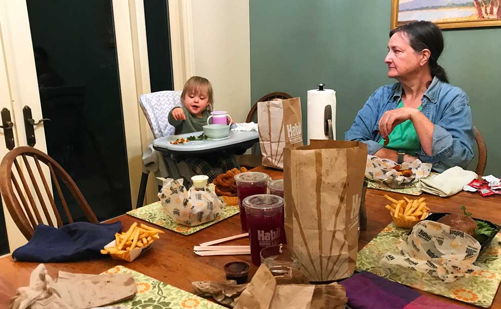 a child and a woman sitting to eat