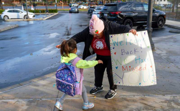 a teacher about to hug a student